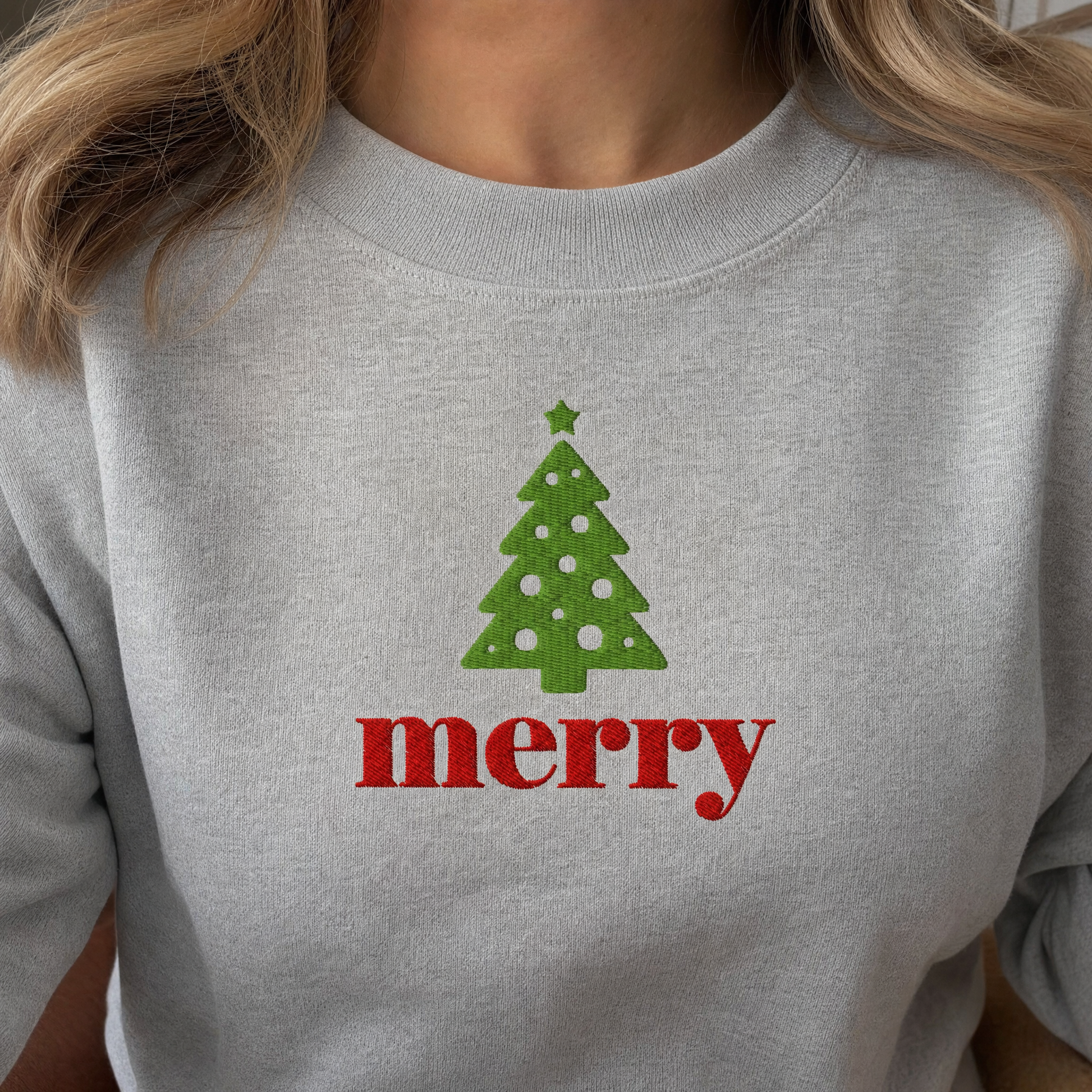 Model wearing the Merry Christmas Tree sweatshirt in Ash, lifestyle image 2