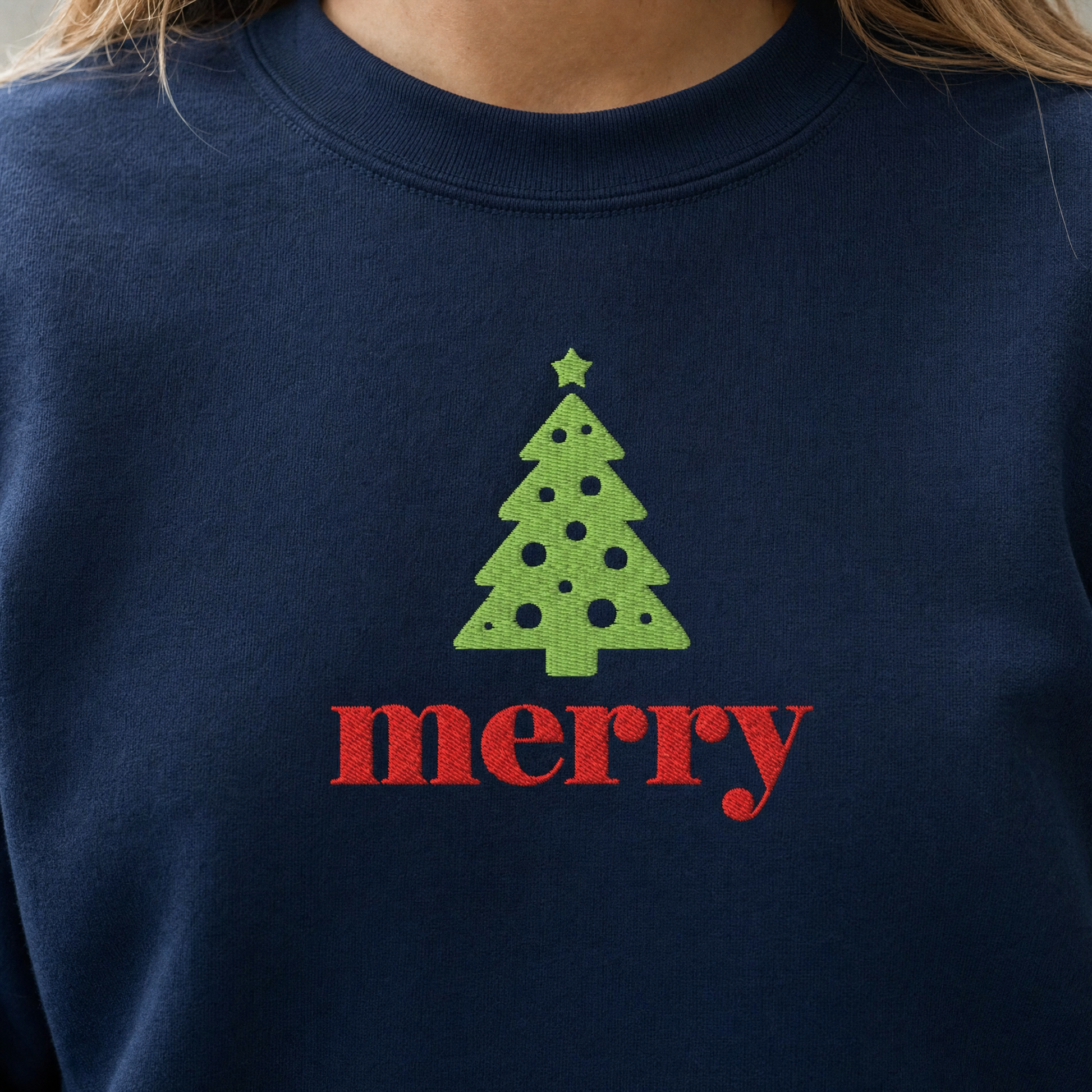 Model wearing the Merry Christmas Tree sweatshirt in Navy, lifestyle image 2