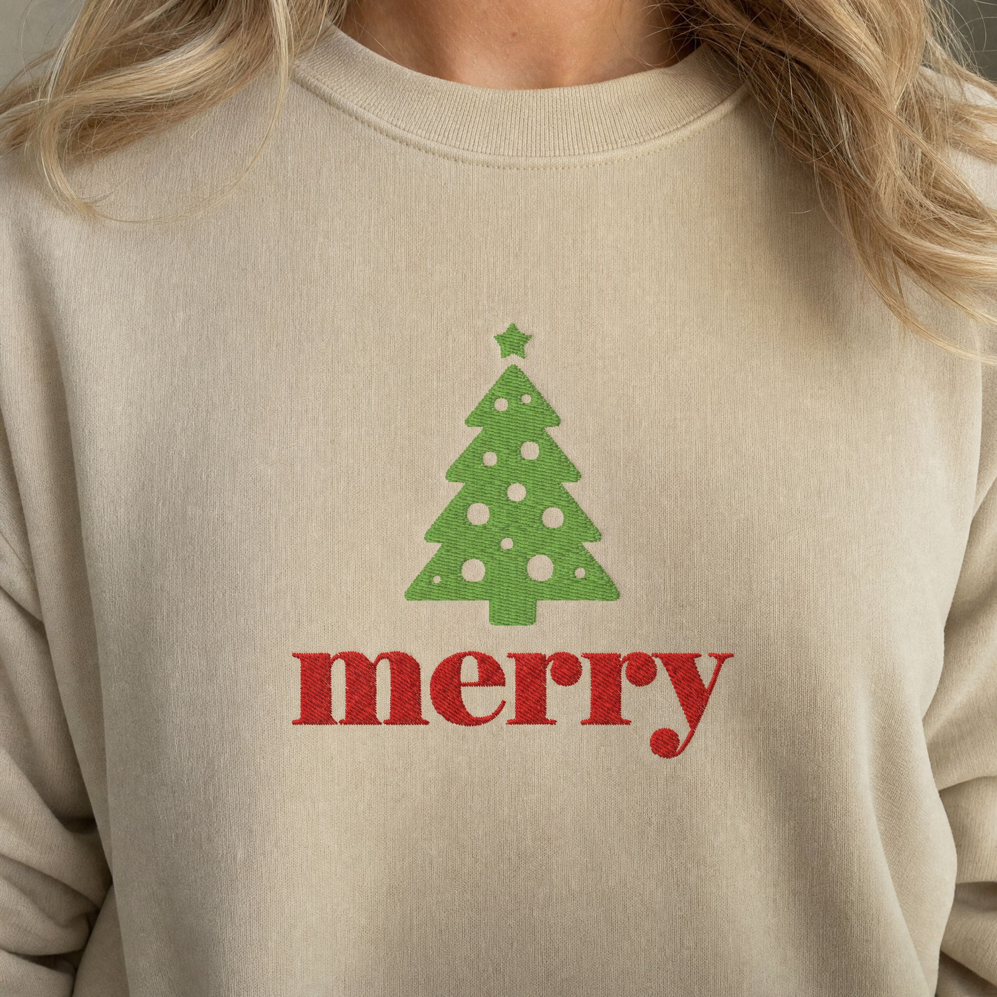 Model wearing the Merry Christmas Tree sweatshirt in Sand, lifestyle image 1