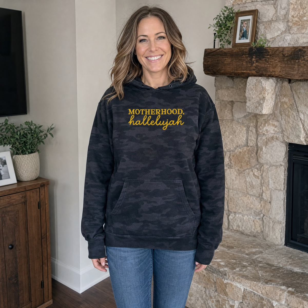 Model wearing the Motherhood Hallelujah heavyweight hoodie in Black Camo, lifestyle image 1