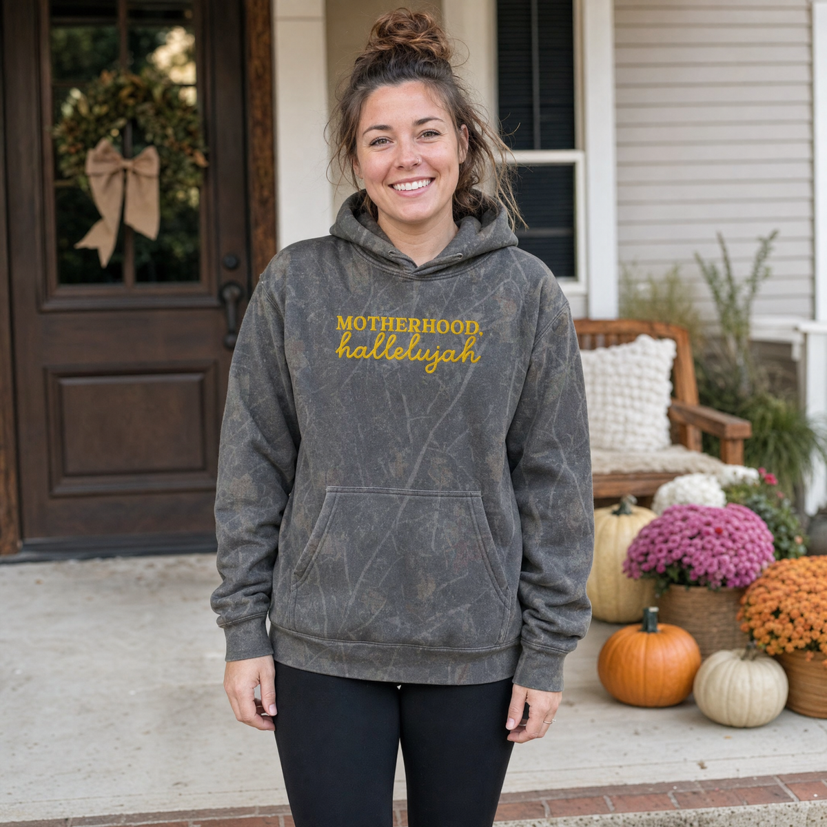 Model wearing the Motherhood Hallelujah heavyweight hoodie in Dark Tree Camo, cover image 1