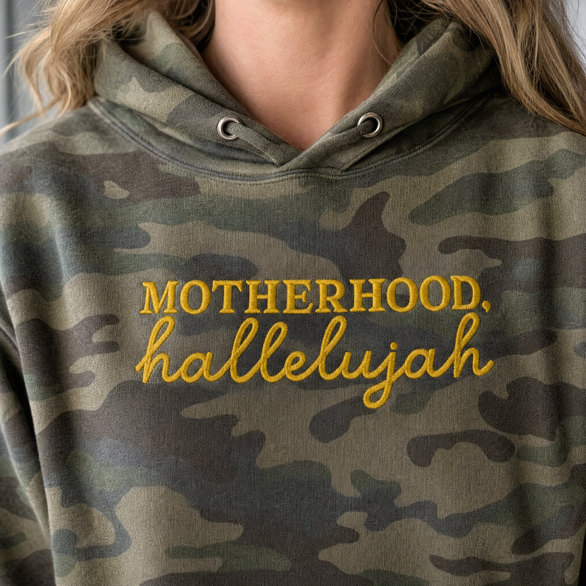 Model wearing the Motherhood Hallelujah heavyweight hoodie in Green Camo, lifestyle image 2