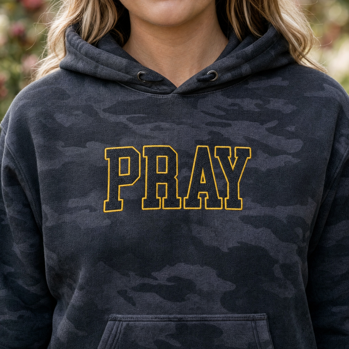 Model wearing the Pray Outline Text heavyweight hoodie in Black Camo, lifestyle image 2