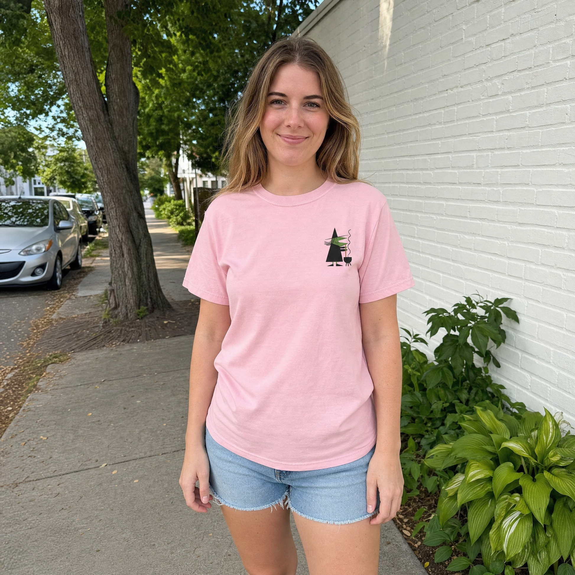 Model wearing the Retro Witch Stirring Cauldron comfort colors tee in Blossom, lifestyle image 1