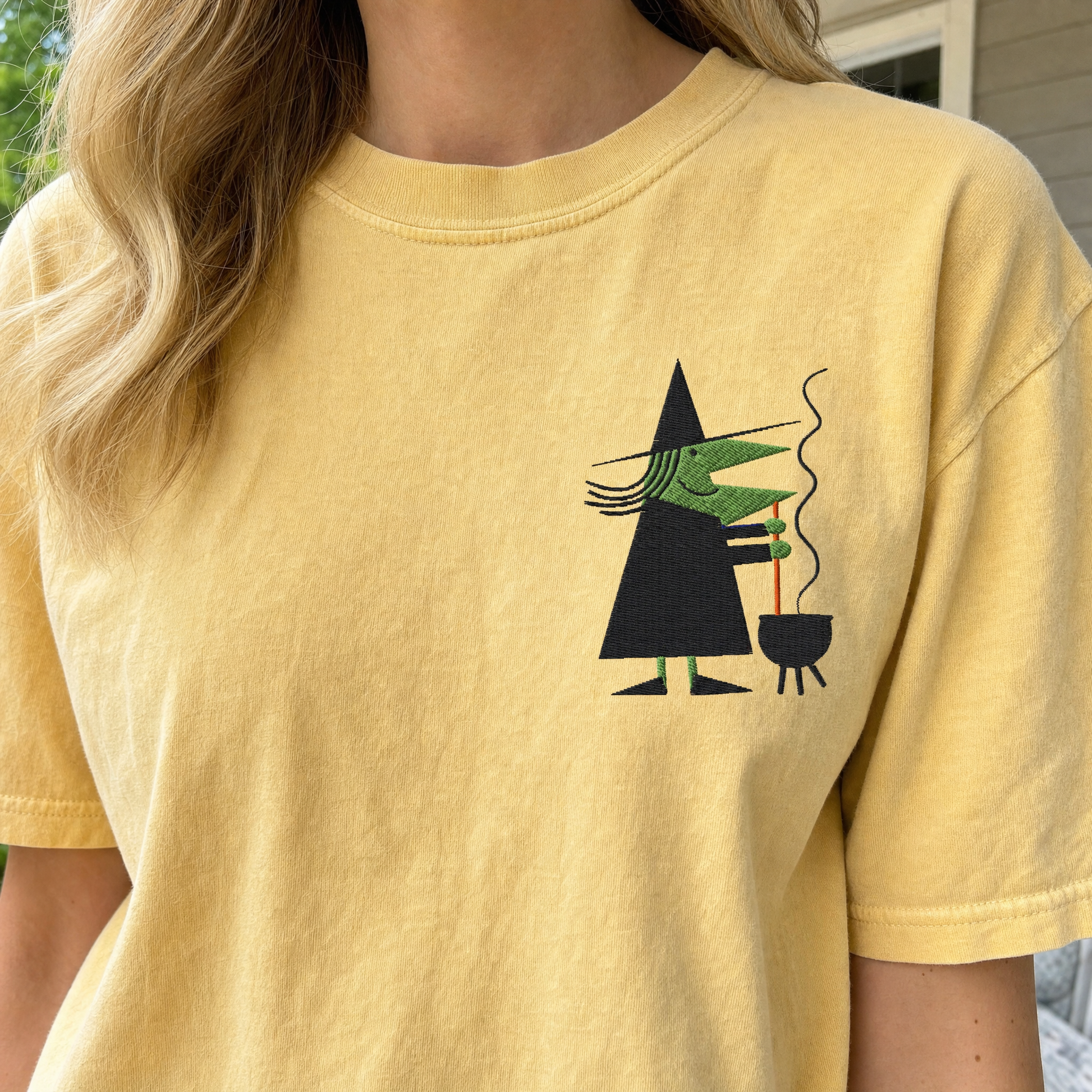 Model wearing the Retro Witch Stirring Cauldron comfort colors tee in Butter, lifestyle image 2