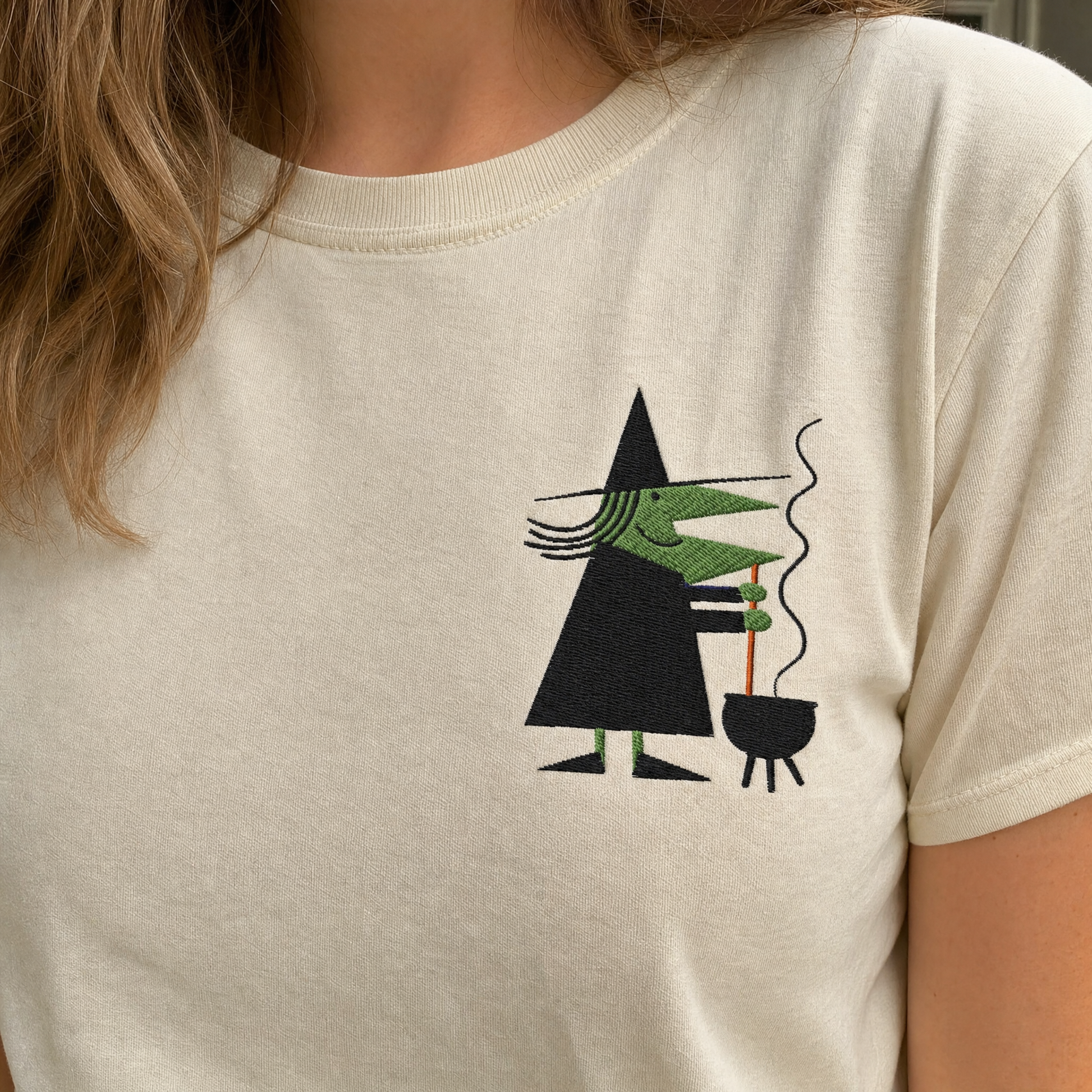 Model wearing the Retro Witch Stirring Cauldron comfort colors tee in Ivory, lifestyle image 2