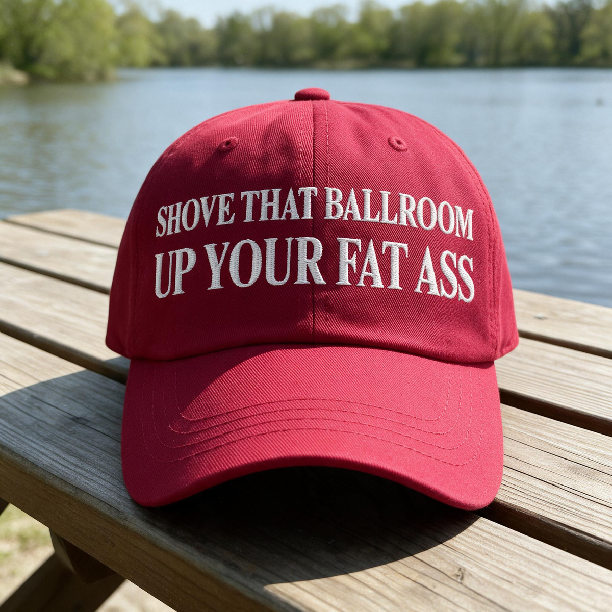 Shove That Ballroom Up Your Fat Ass embroidered hat in Cranberry resting on a flat surface, lifestyle image 1