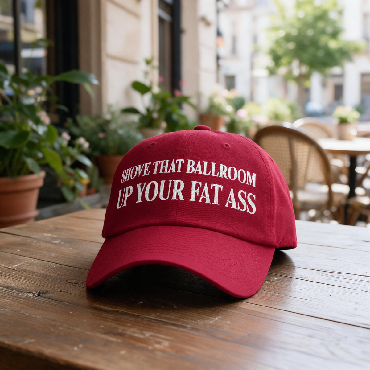 Shove That Ballroom Up Your Fat Ass embroidered hat in Cranberry resting on a flat surface, lifestyle image 2