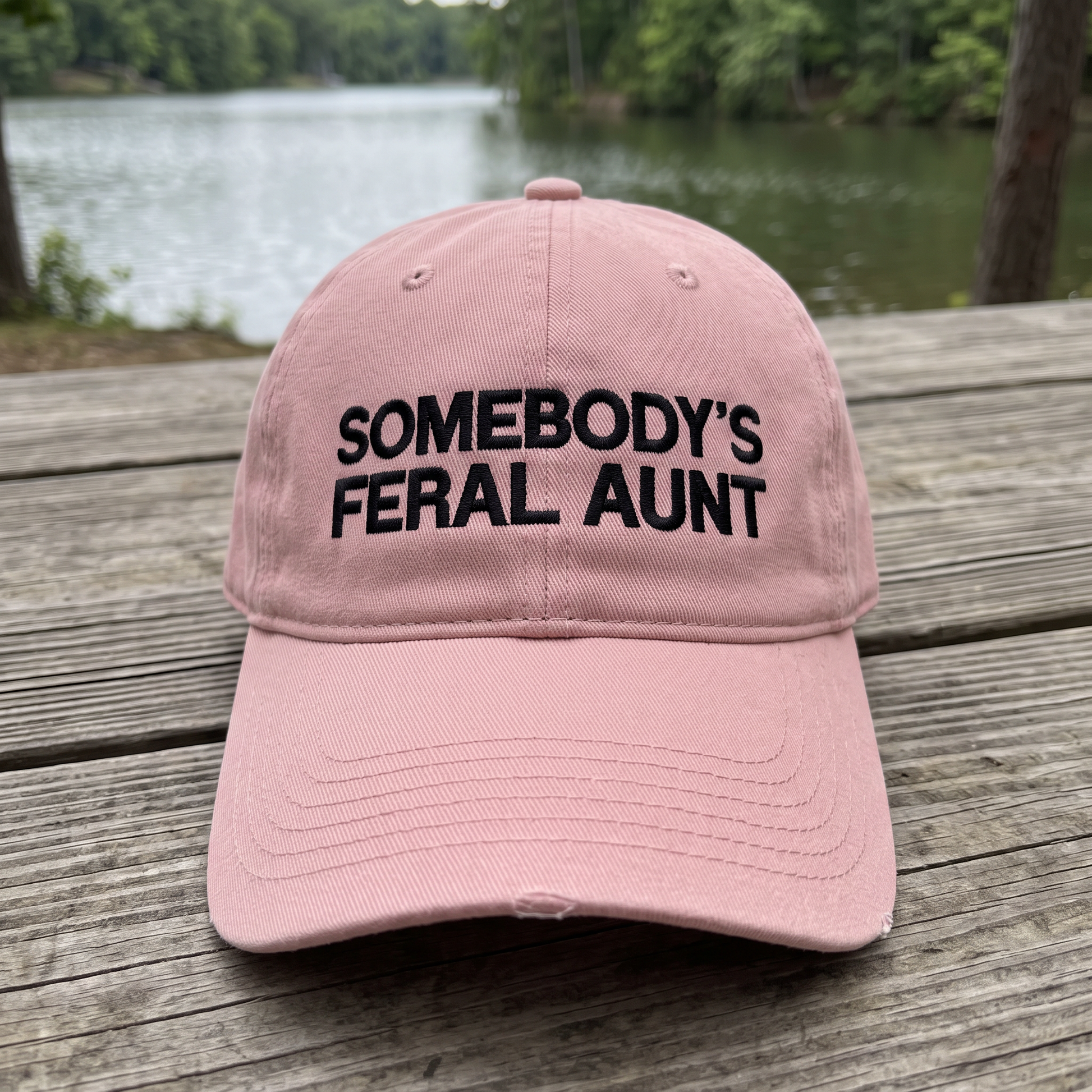 Somebody's Feral Aunt embroidered hat in Dusty Rose resting on a flat surface, lifestyle image 1