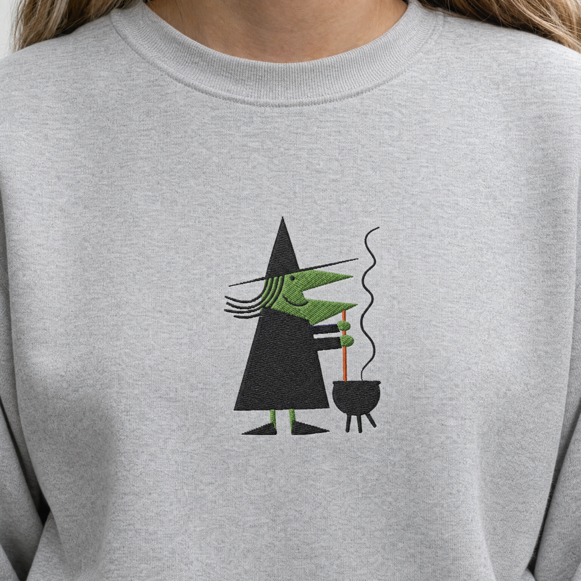 Model wearing the Witch Stirring Cauldron sweatshirt in Ash, lifestyle image 1