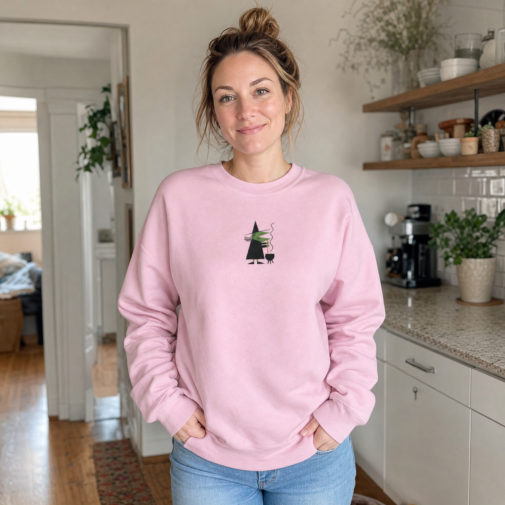 Model wearing the Witch Stirring Cauldron sweatshirt in Light Pink, lifestyle image 1