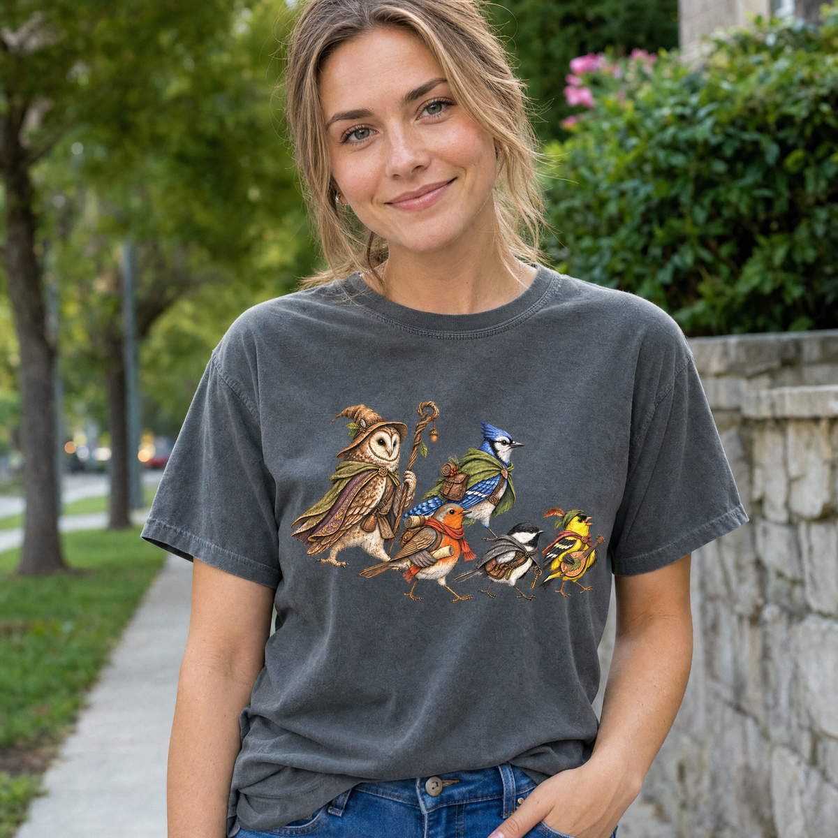 Model wearing the Fantasy Bird Adventurers comfort colors tee in Pepper, lifestyle image 1