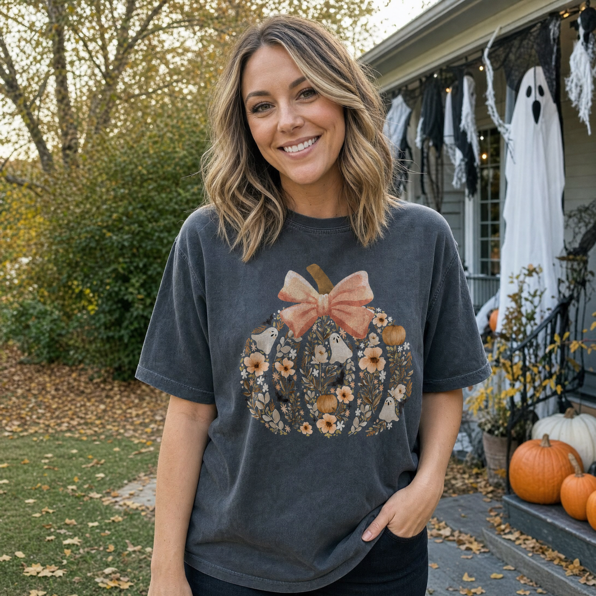 Model wearing the Floral Pumpkin comfort colors tee in Pepper, lifestyle image 1