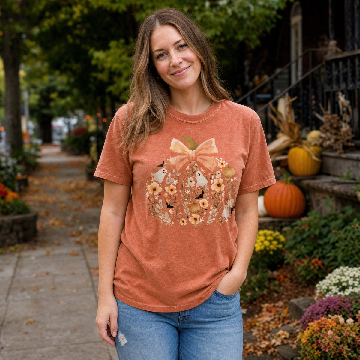 Model wearing the Floral Pumpkin comfort colors tee in Yam