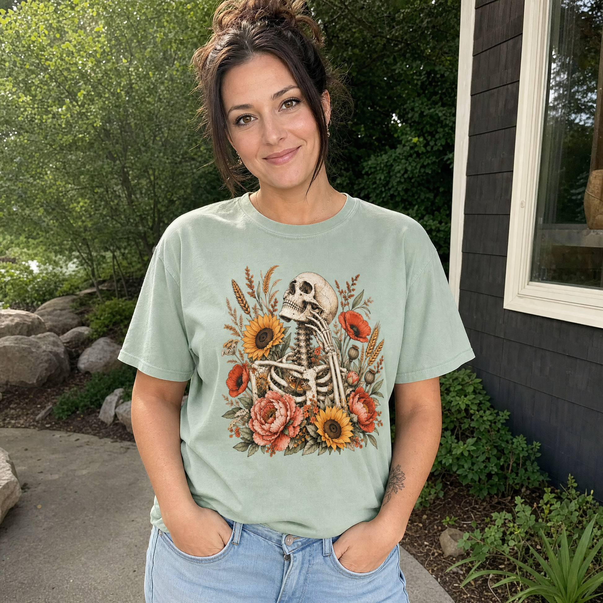 Model wearing the Floral Skeleton comfort colors tee in Bay
