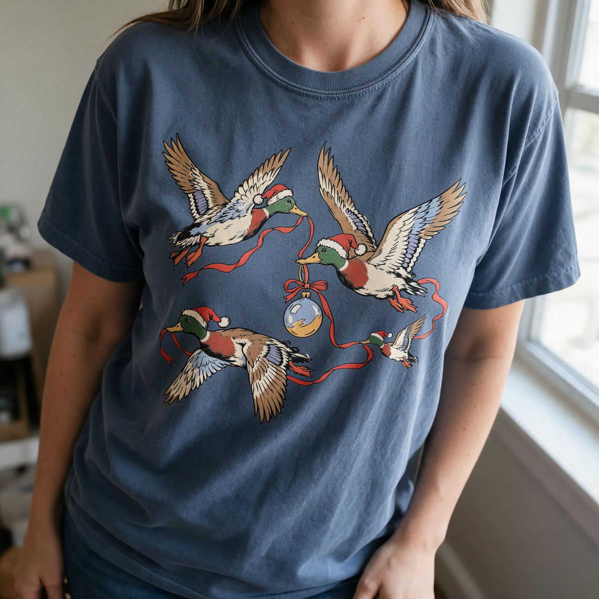 Model wearing the Flying Mallard Ducks comfort colors tee in Denim
