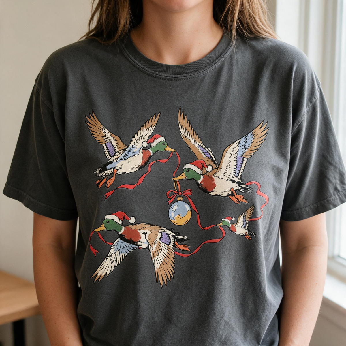 Model wearing the Flying Mallard Ducks comfort colors tee in Pepper