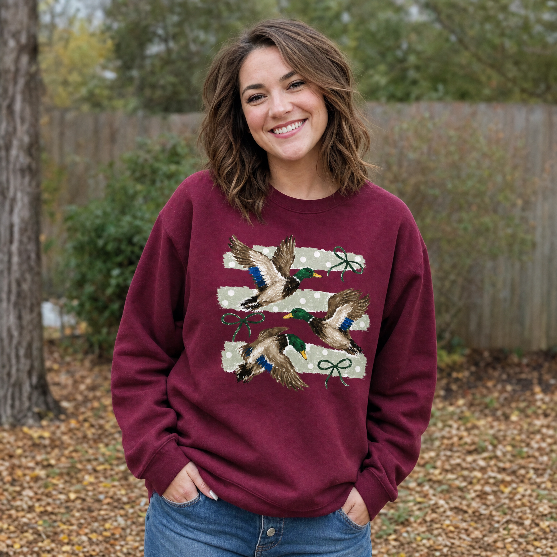 Model wearing the Flying Mallard Ducks sweatshirt in Maroon, lifestyle image 1