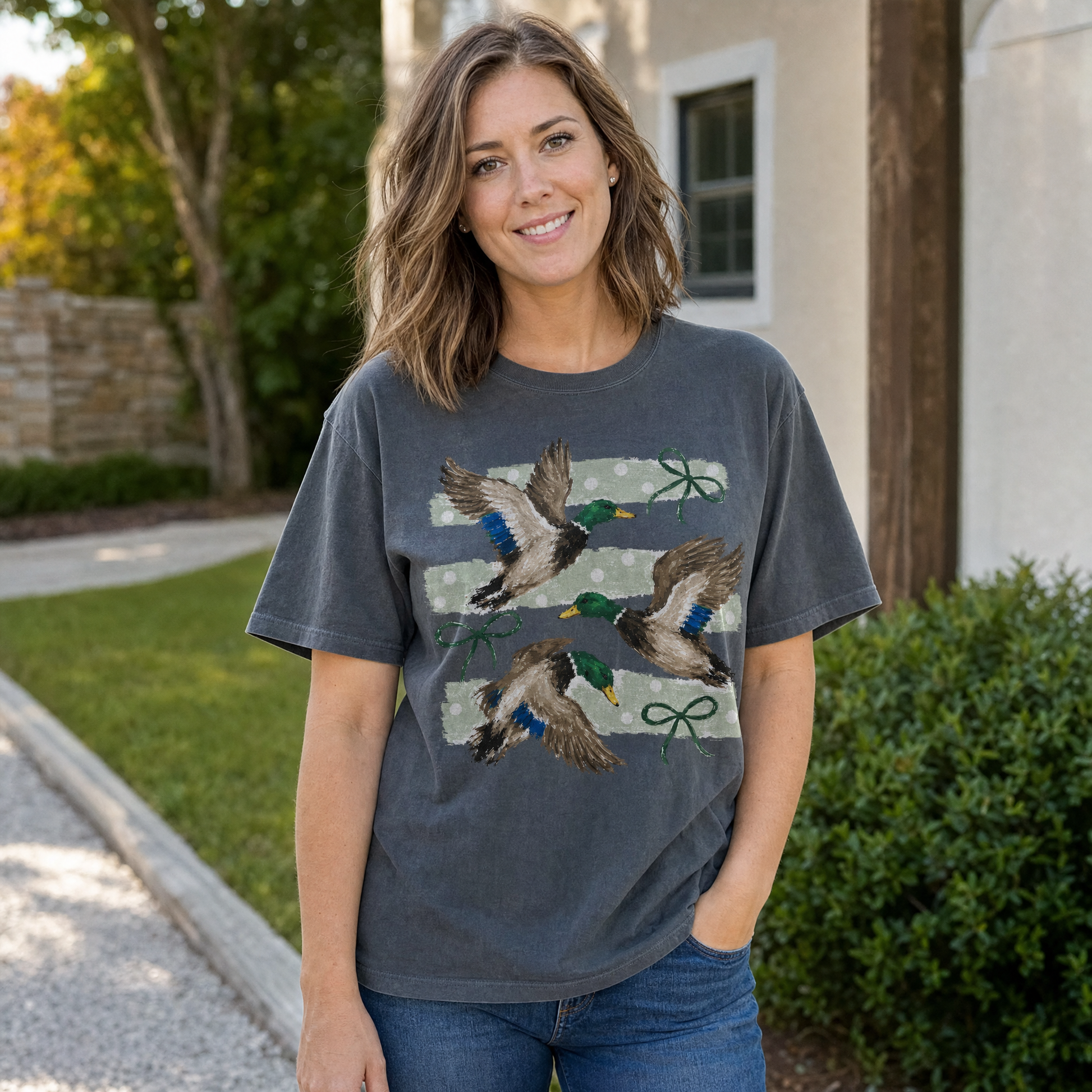 Model wearing the Flying Mallard Ducks comfort colors tee in Pepper