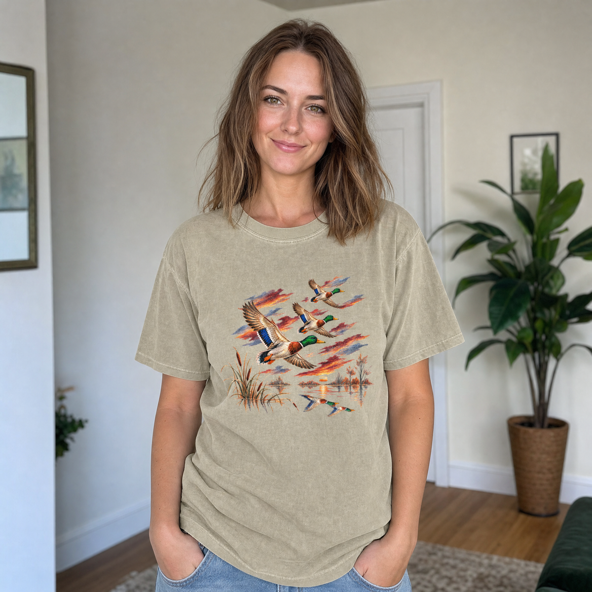 Model wearing the Flying Mallard Ducks comfort colors tee in Khaki, lifestyle image 1