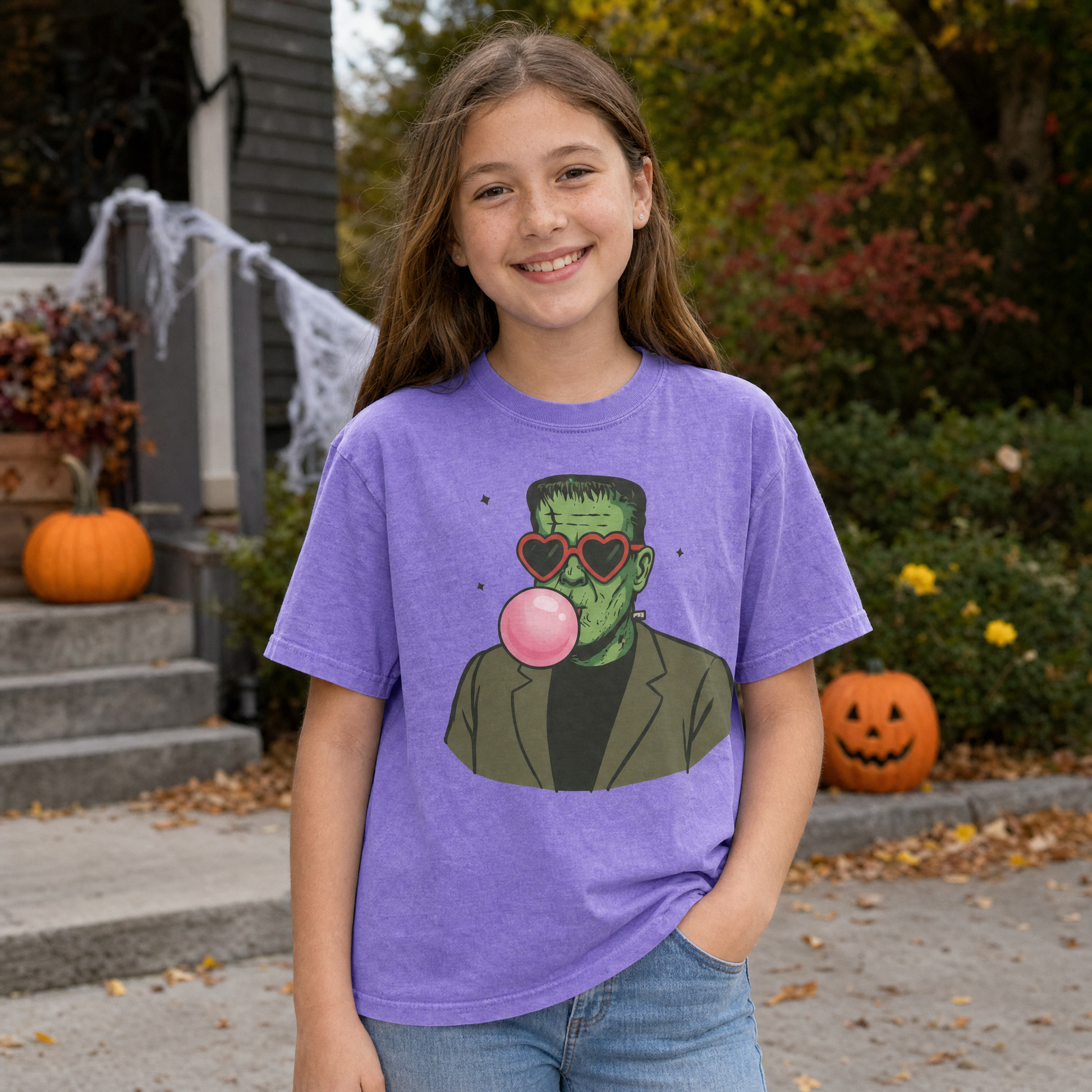 Model wearing the Frankenstein Monster youth comfort colors tee in Violet