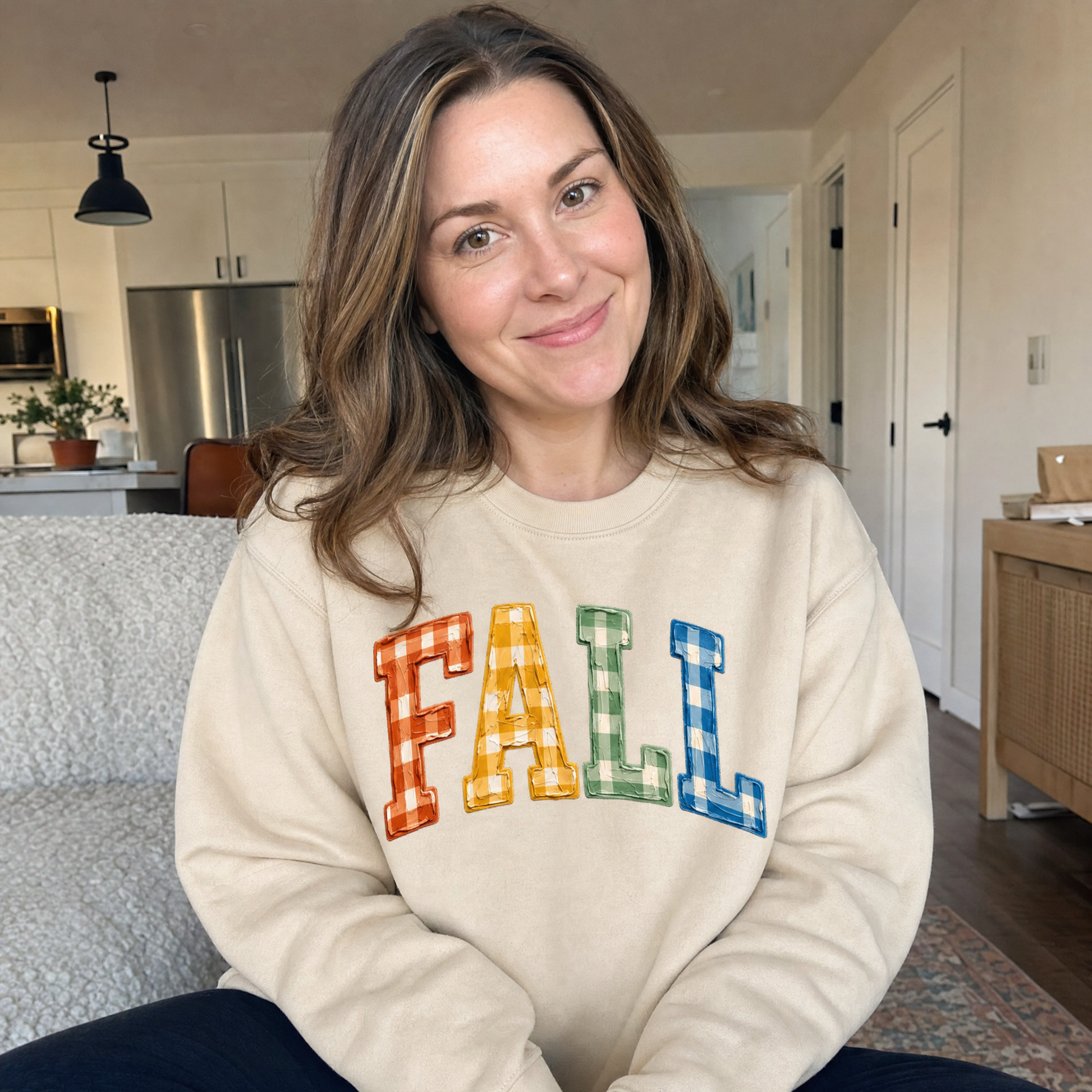 Model wearing the Gingham Fall Letters sweatshirt in Sand