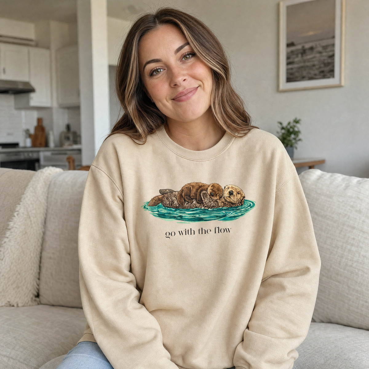 Model wearing the Go With The Flow sweatshirt in Sand, lifestyle image 1