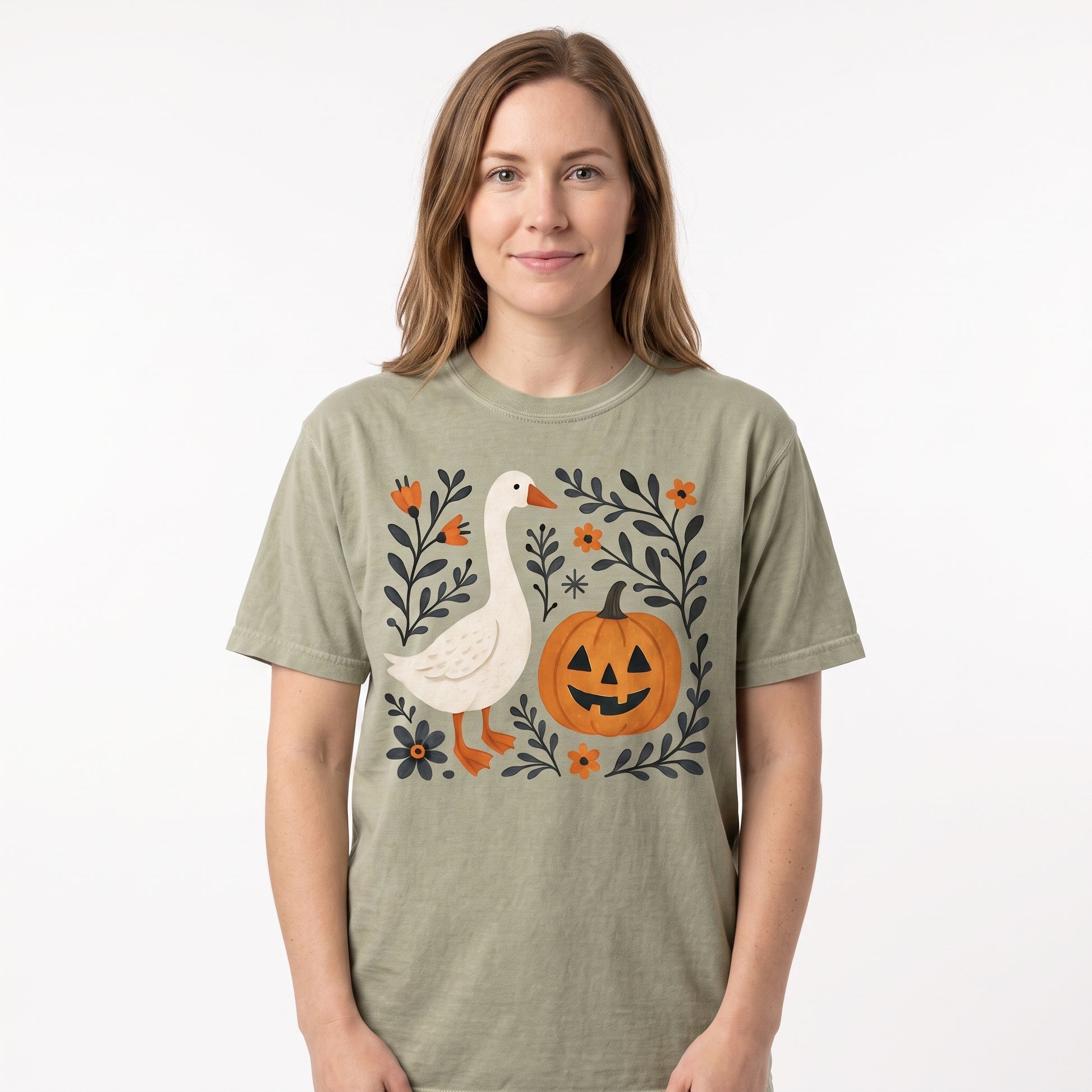 Model wearing the Goose Jack-o'-lantern comfort colors tee in Khaki, cover image 1