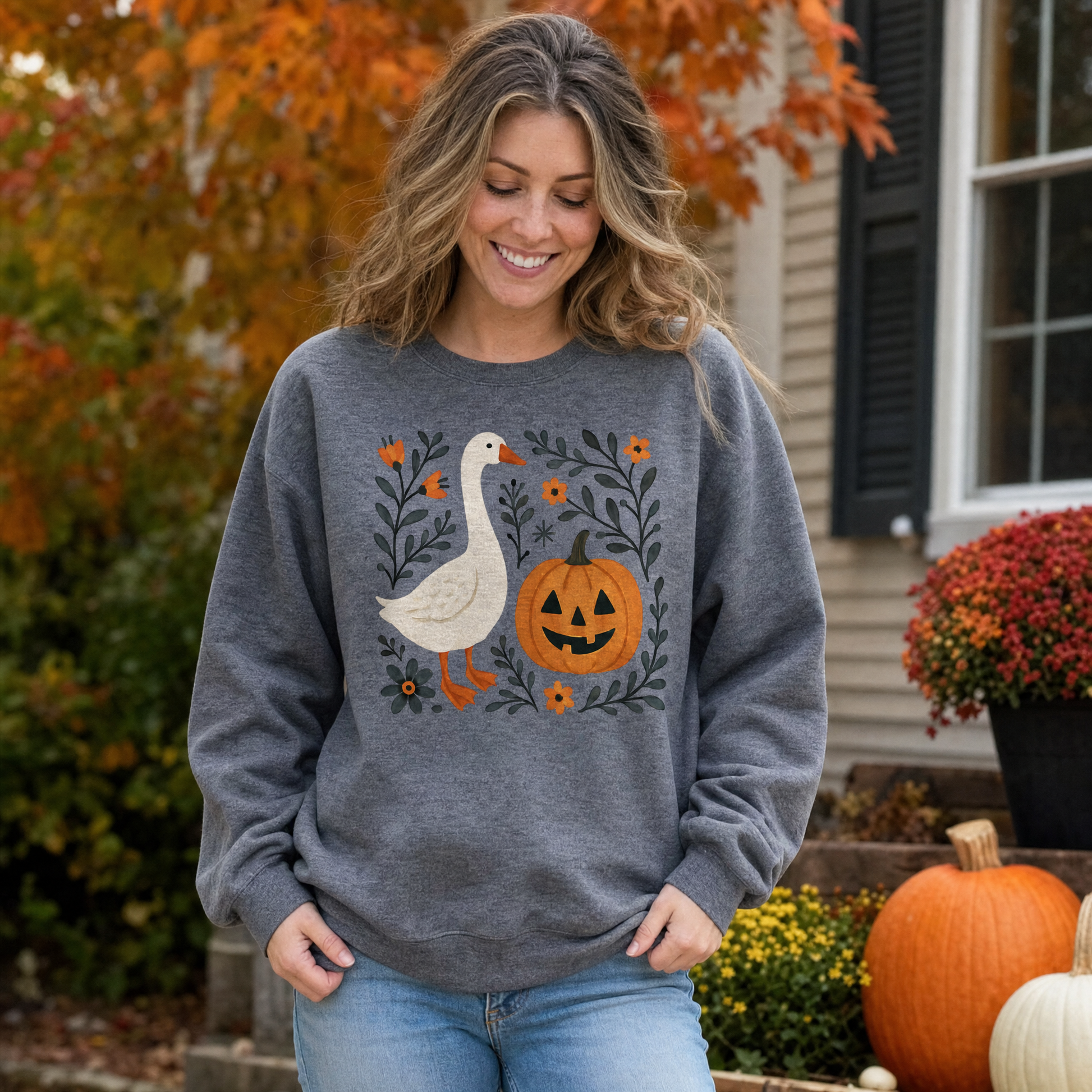 Model wearing the Goose Jack-o'-lantern sweatshirt in Dark Heather