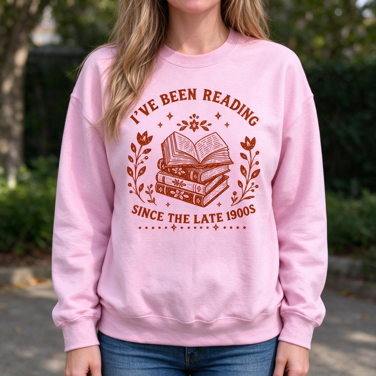 Model wearing the I've Been Reading Since The Late 1900s sweatshirt in Light Pink