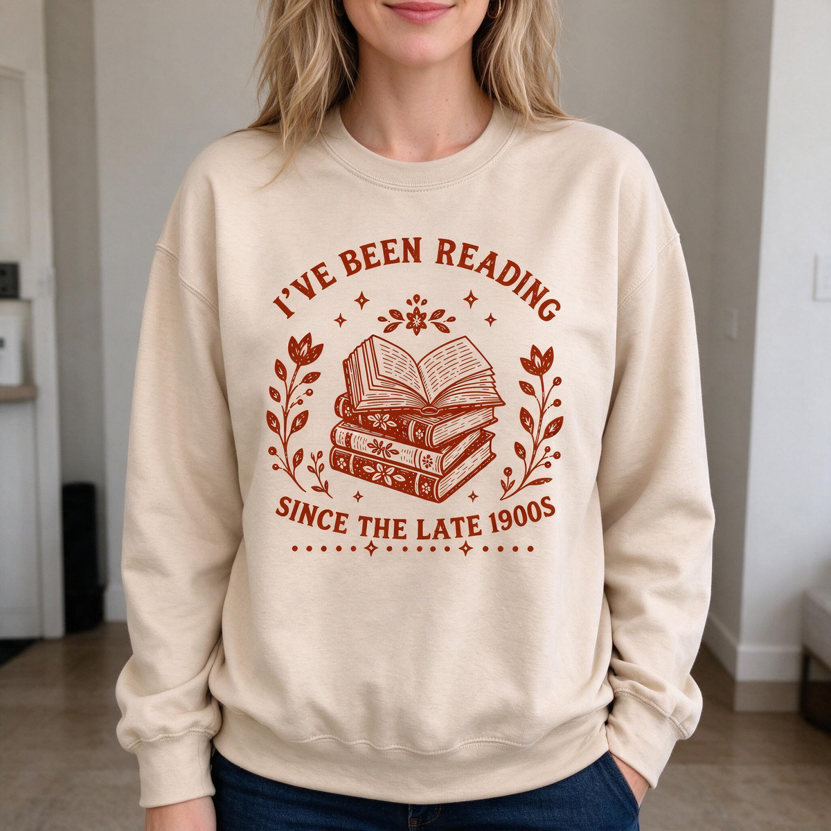 Model wearing the I've Been Reading Since The Late 1900s sweatshirt in Sand
