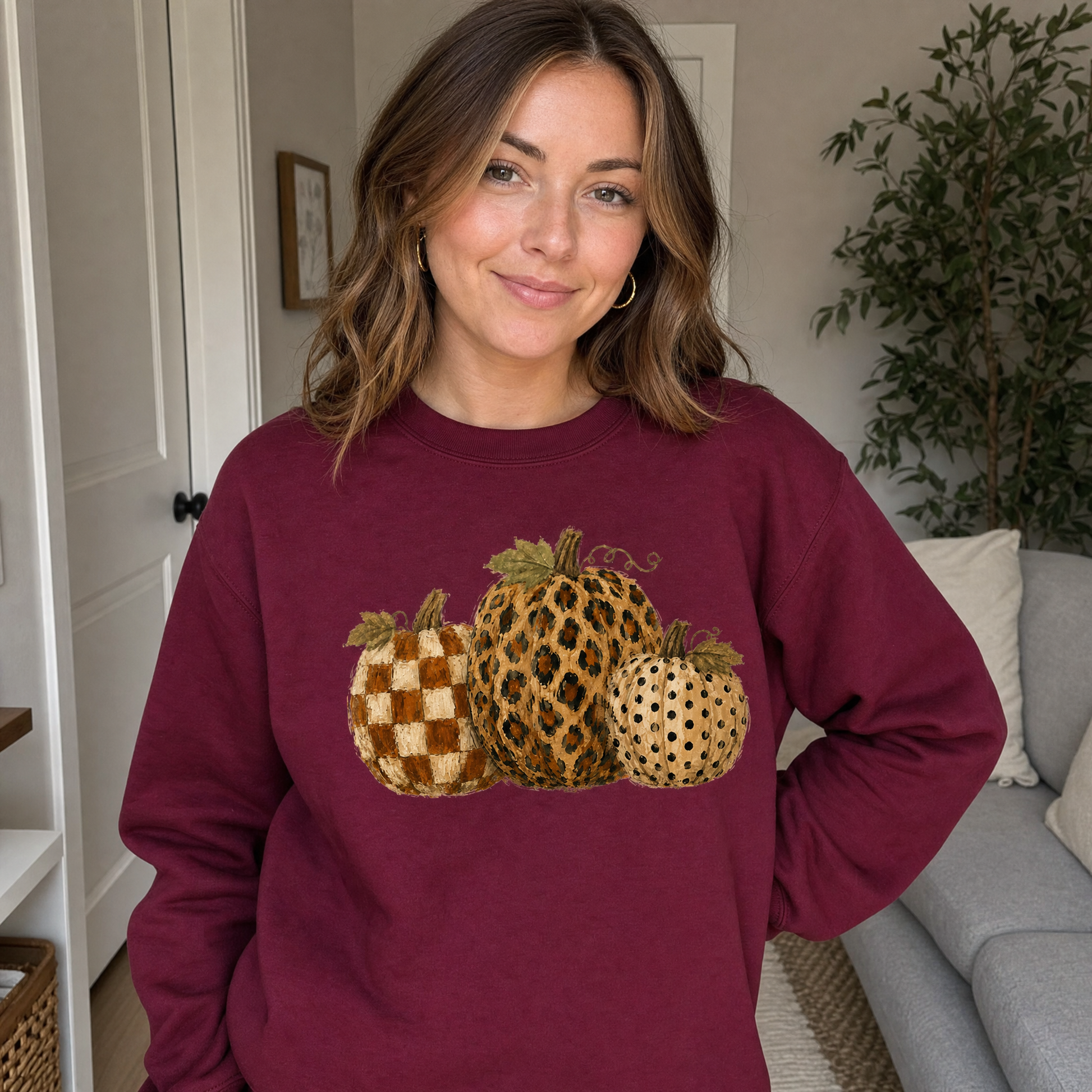 Model wearing the Leopard Polka Dot Pumpkins sweatshirt in Maroon