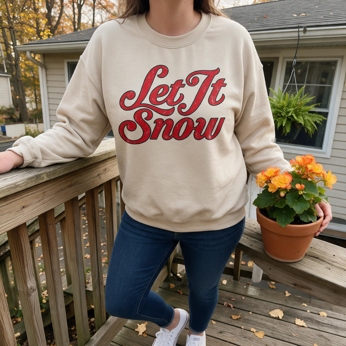 Model wearing the Let It Snow sweatshirt in Sand