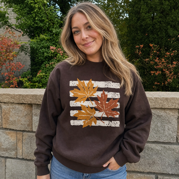 Model wearing the Maple Leaves sweatshirt in Dark Chocolate, lifestyle image 1