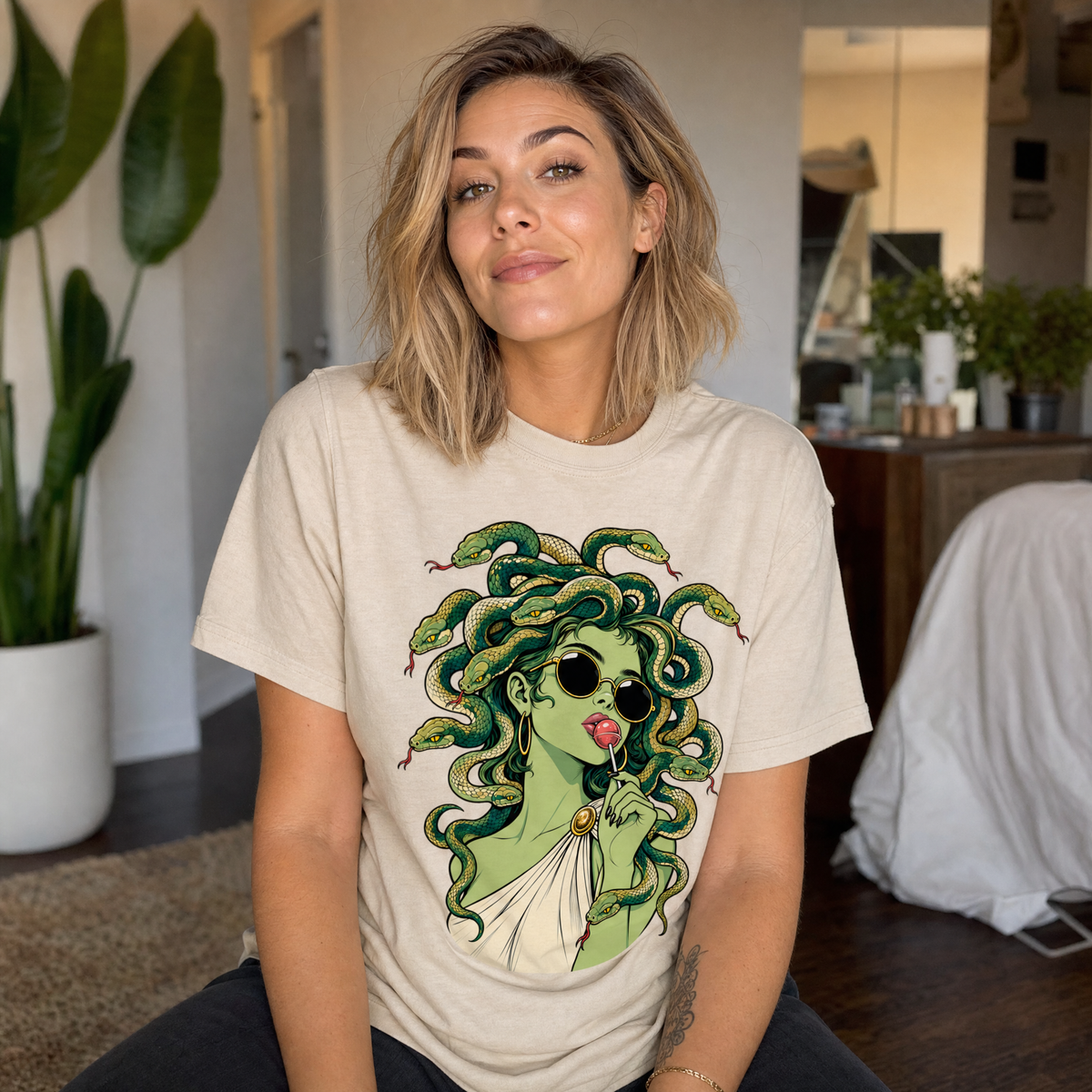 Model wearing the Medusa With Lollipop comfort colors tee in Ivory