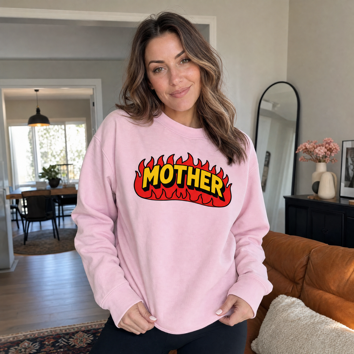 Model wearing the Mother Flaming Text sweatshirt in Light Pink