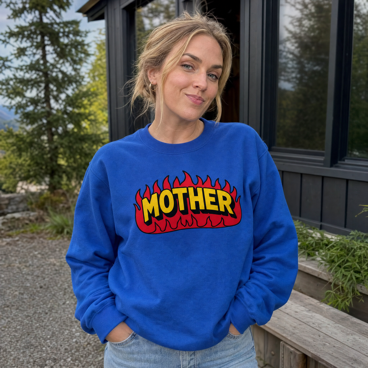 Model wearing the Mother Flaming Text sweatshirt in Royal, lifestyle image 1