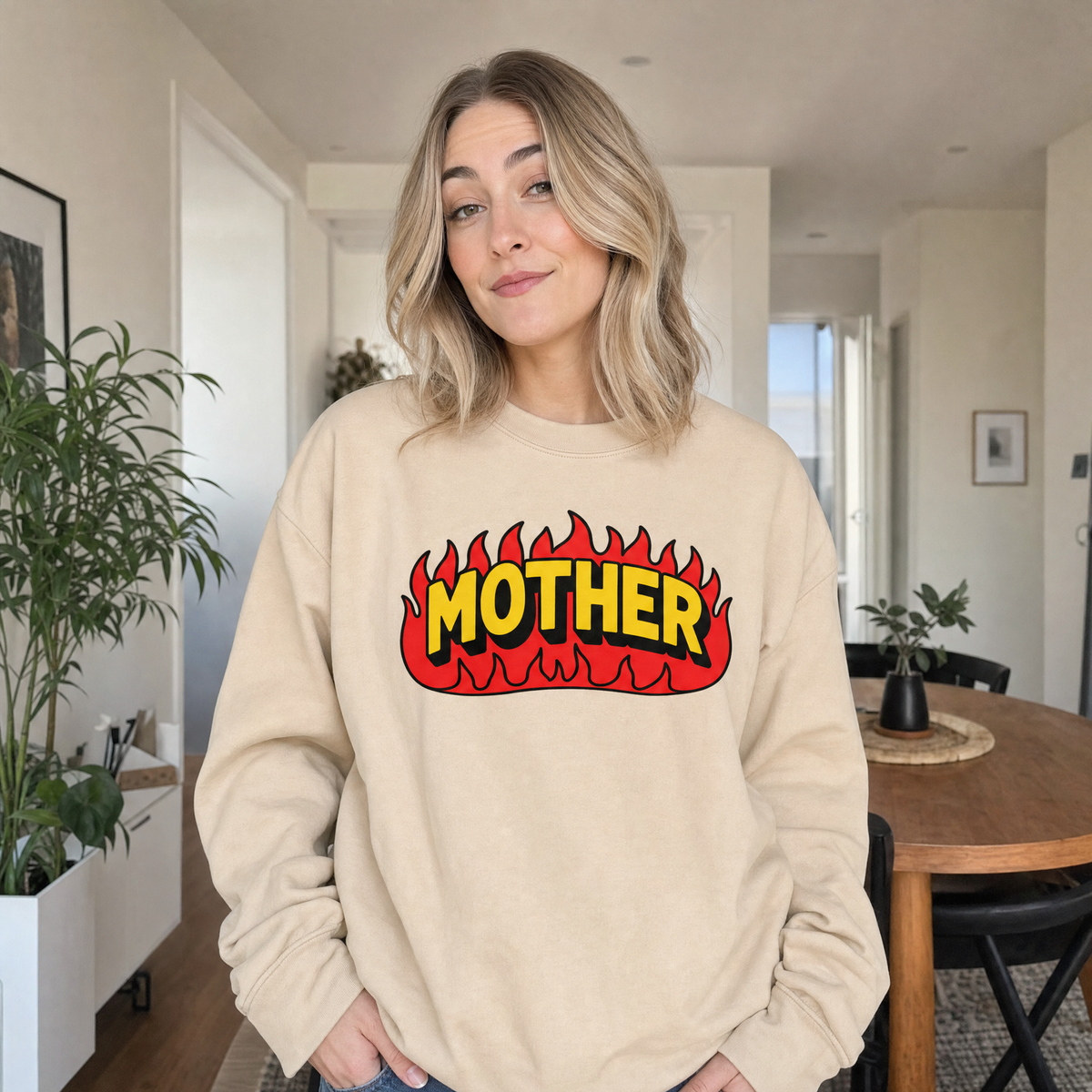 Model wearing the Mother Flaming Text sweatshirt in Sand