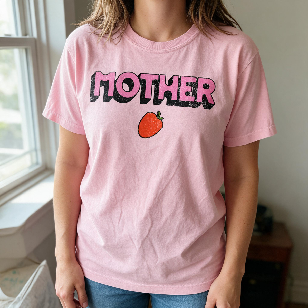 Model wearing the Mother Strawberry comfort colors tee in Blossom