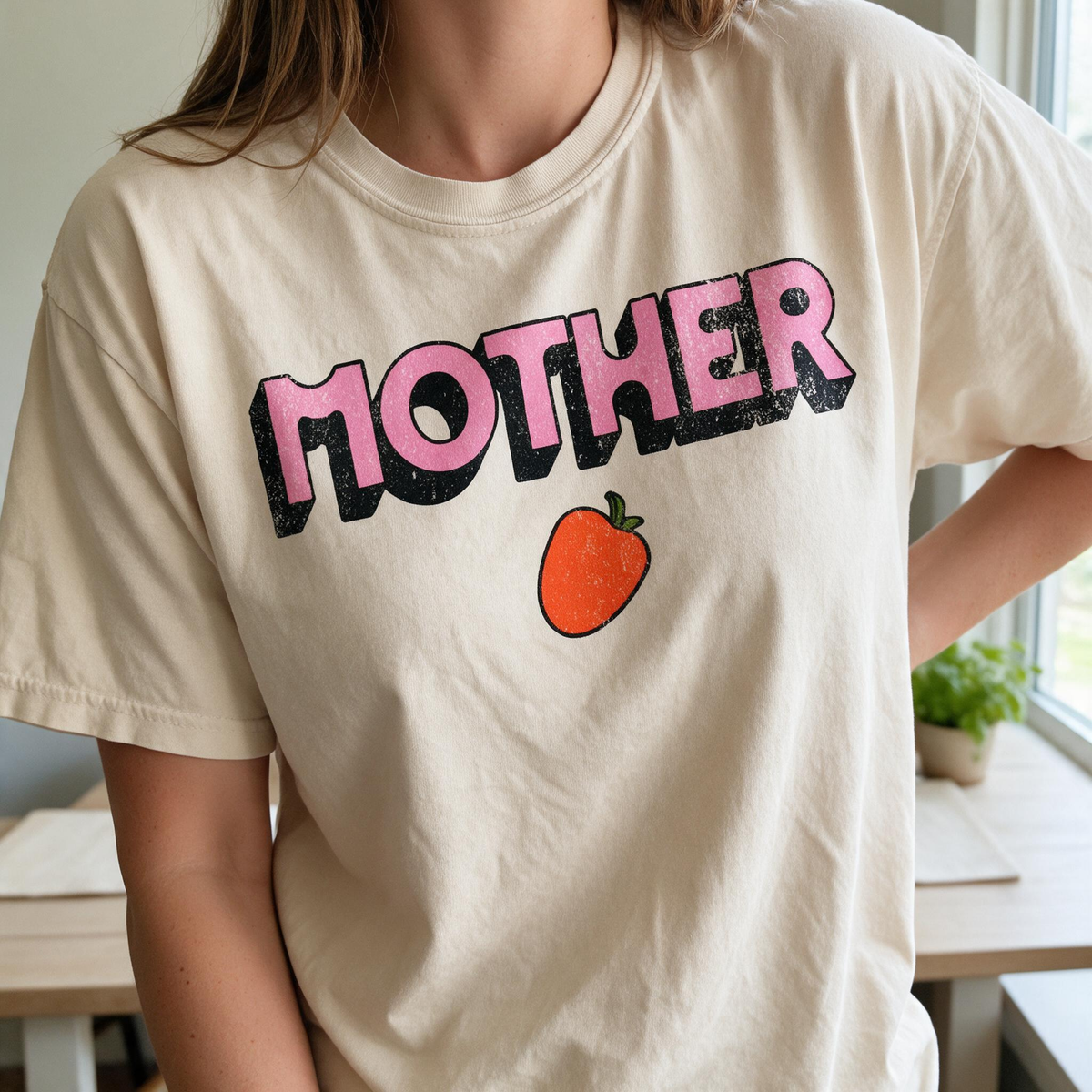 Model wearing the Mother Strawberry comfort colors tee in Ivory, lifestyle image 1
