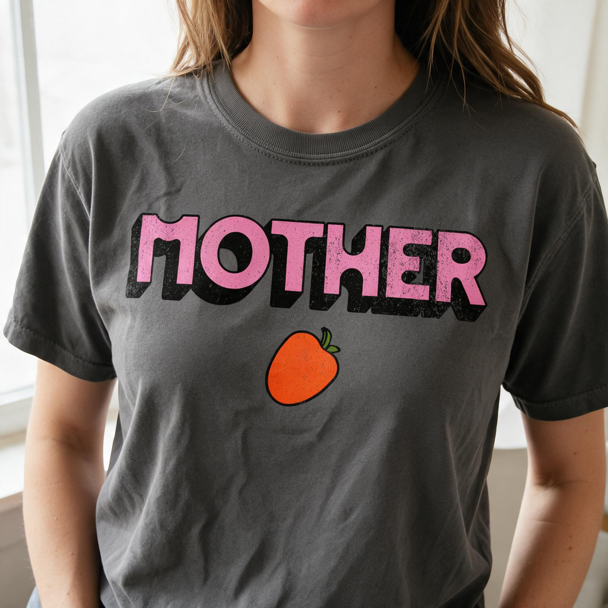 Model wearing the Mother Strawberry comfort colors tee in Pepper