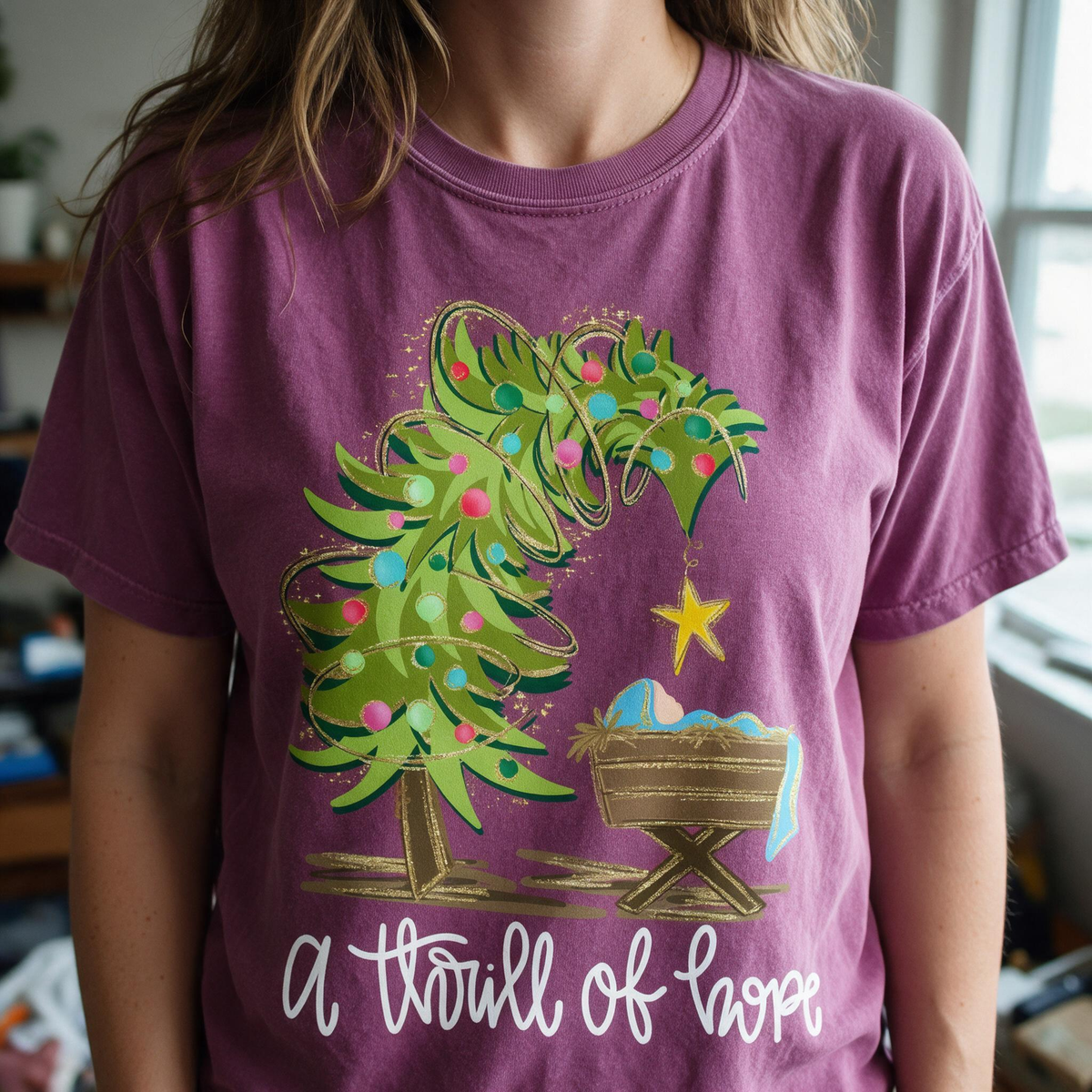 Model wearing the Nativity Scene comfort colors tee in Berry