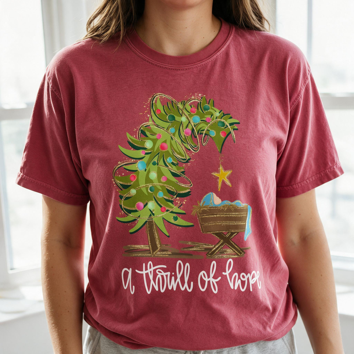 Model wearing the Nativity Scene comfort colors tee in Crimson