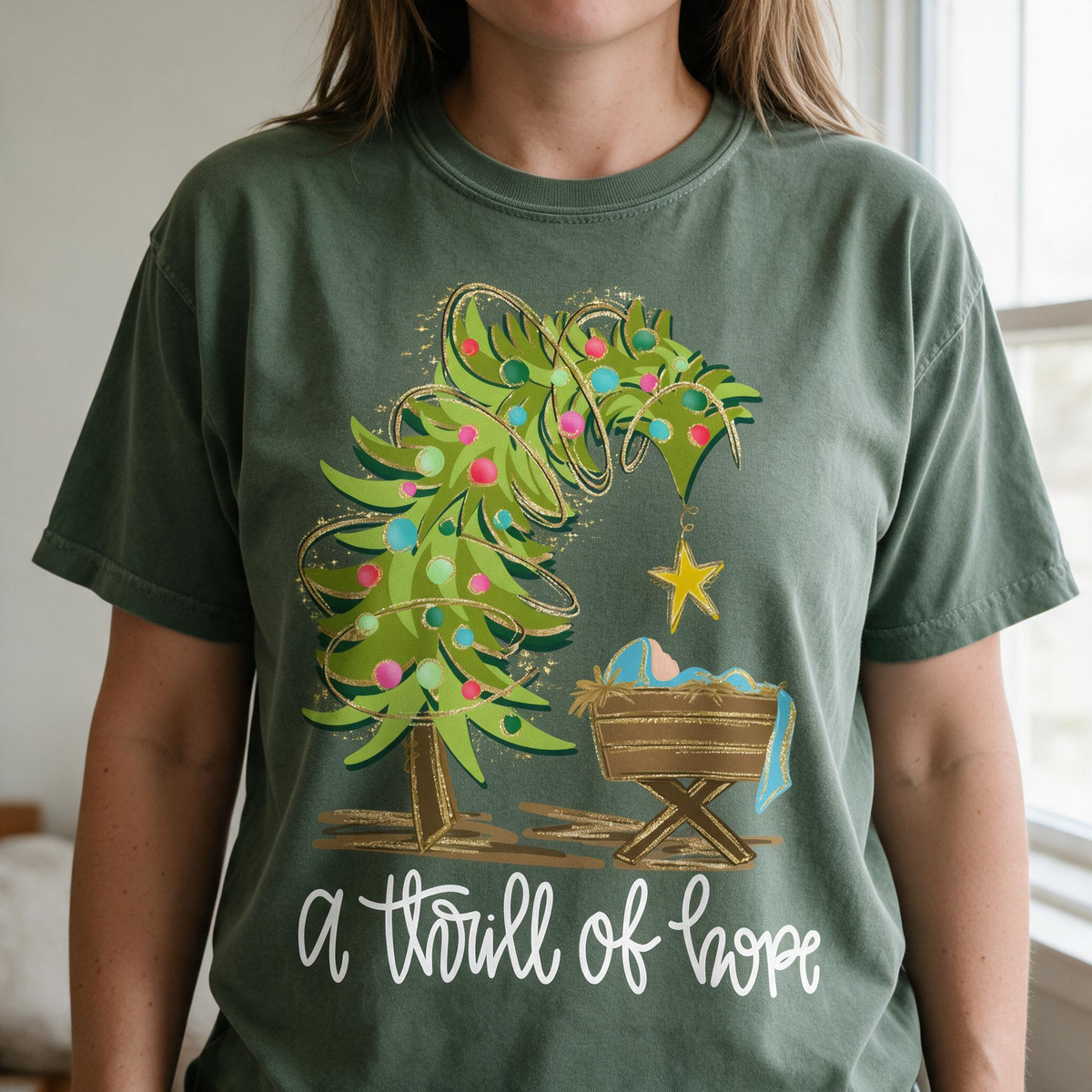 Model wearing the Nativity Scene comfort colors tee in Moss