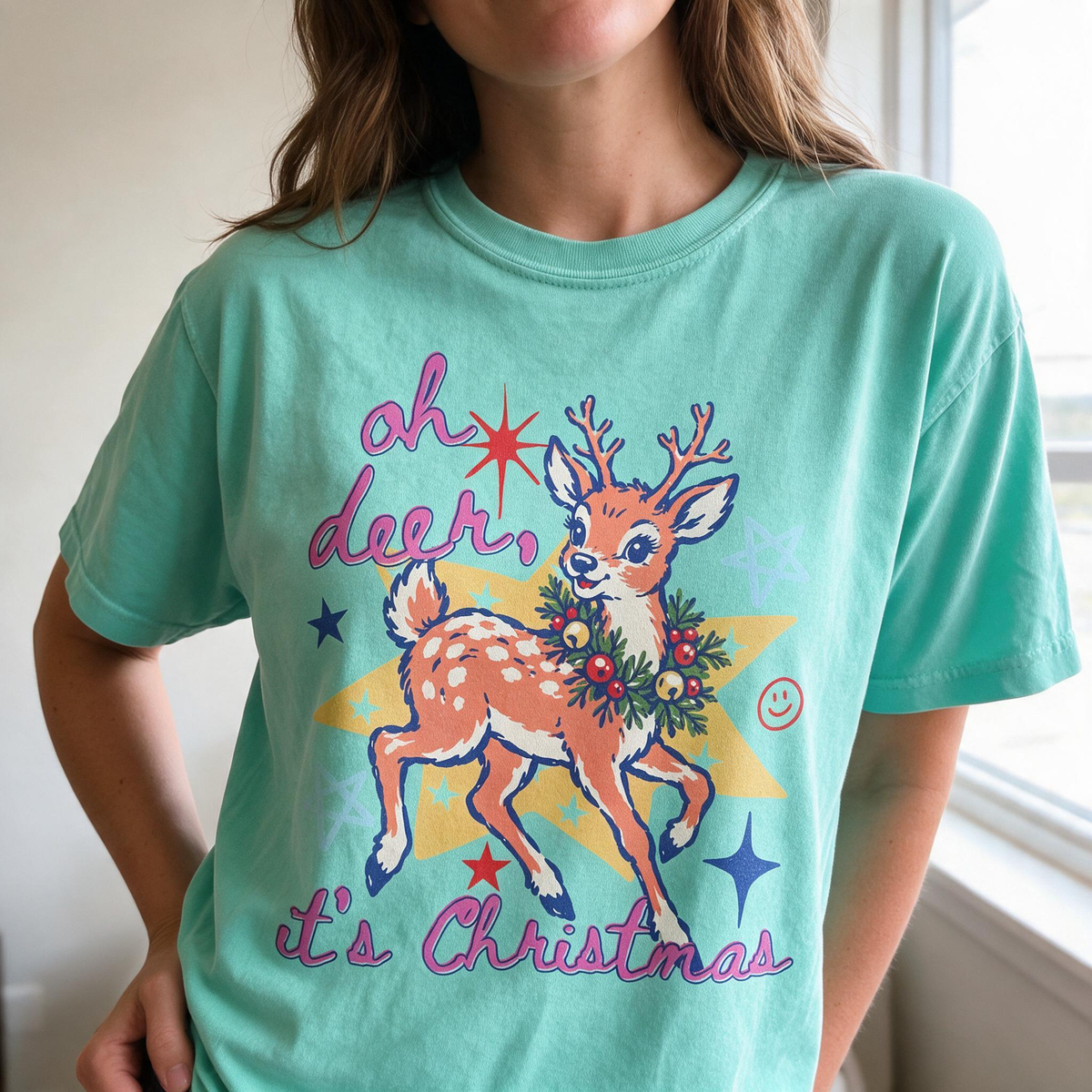 Model wearing the Oh Deer It's Christmas comfort colors tee in Island Reef