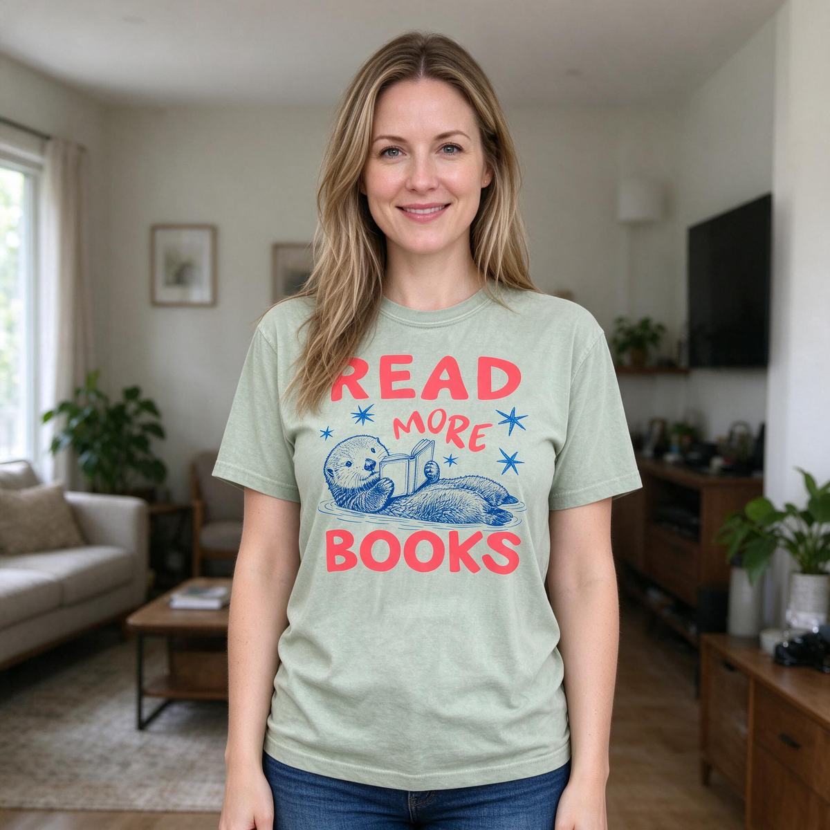 Model wearing the Otter Reading Book comfort colors tee in Bay