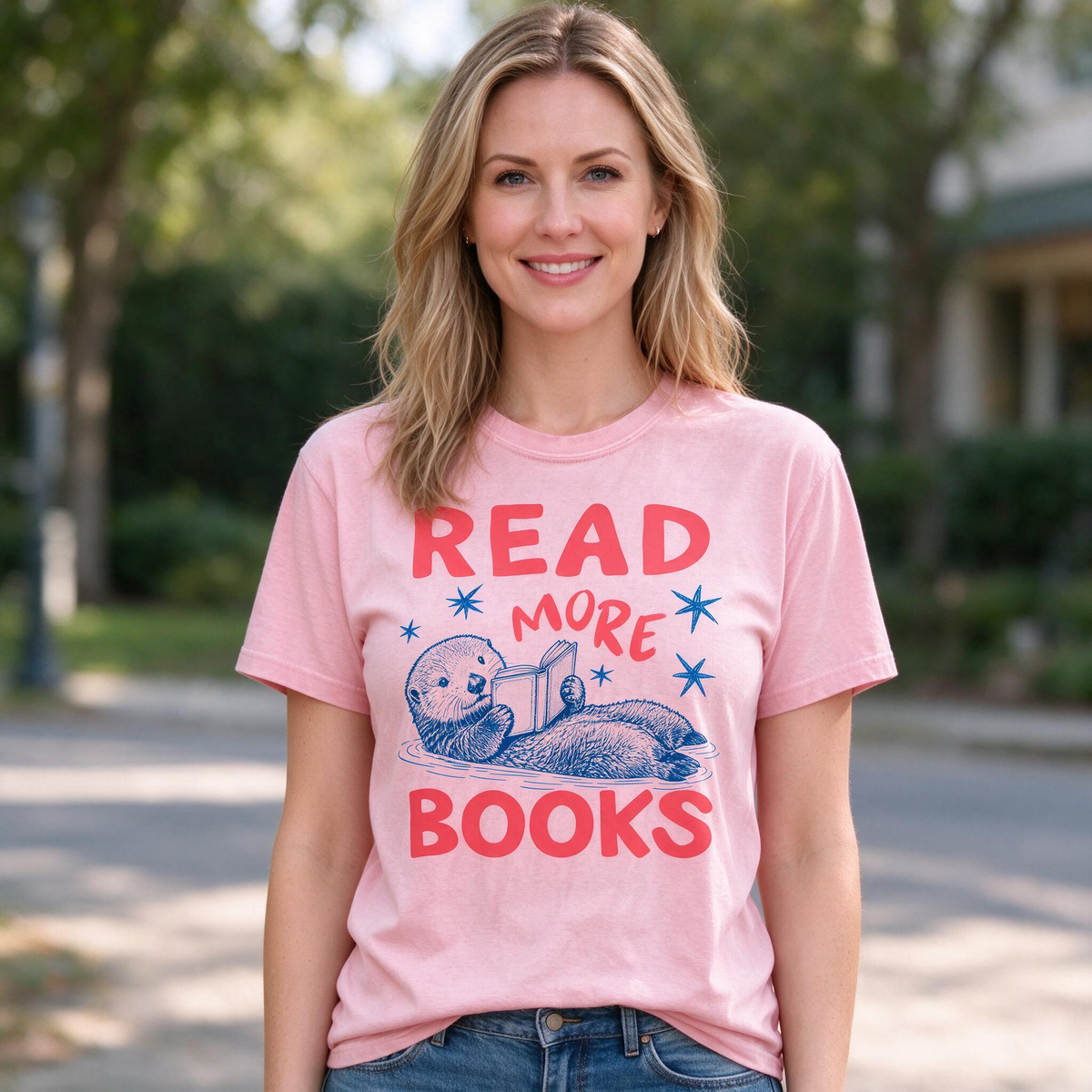 Model wearing the Otter Reading Book comfort colors tee in Blossom