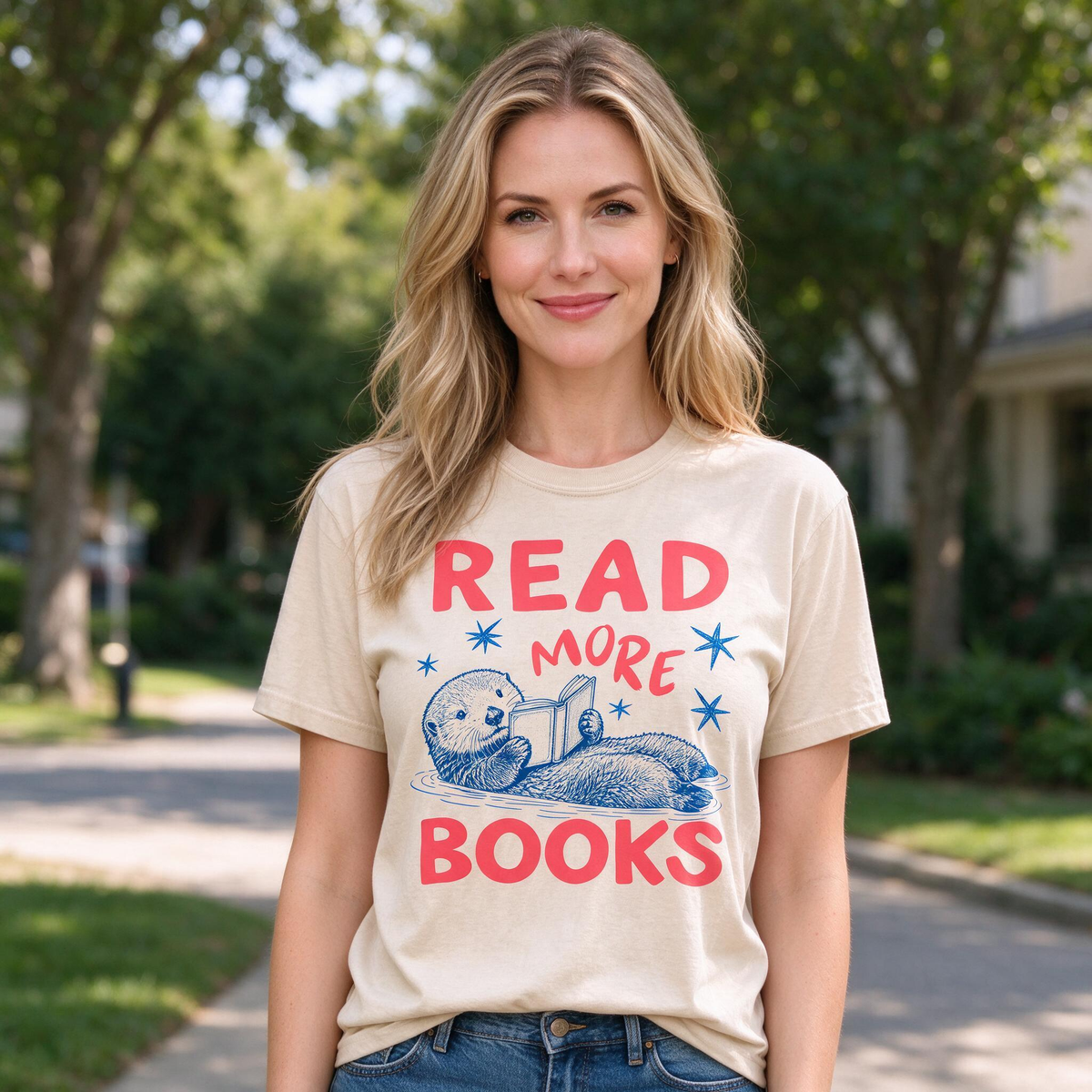 Model wearing the Otter Reading Book comfort colors tee in Ivory, lifestyle image 1