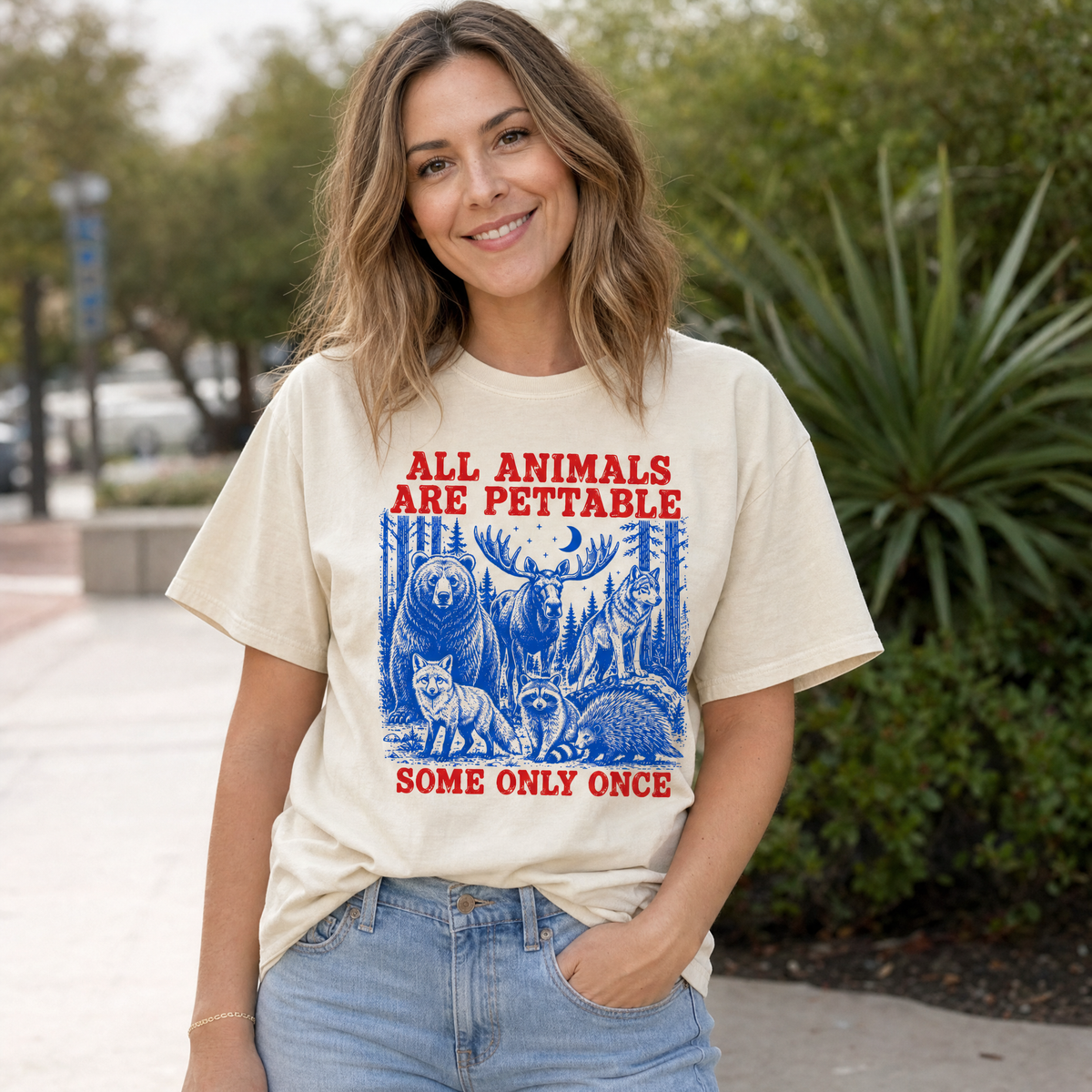 Model wearing the Pettable Animals comfort colors tee in Ivory, lifestyle image 1