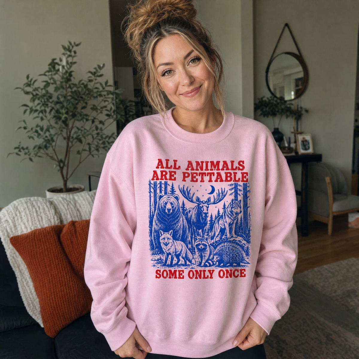 Model wearing the Pettable Animals sweatshirt in Light Pink